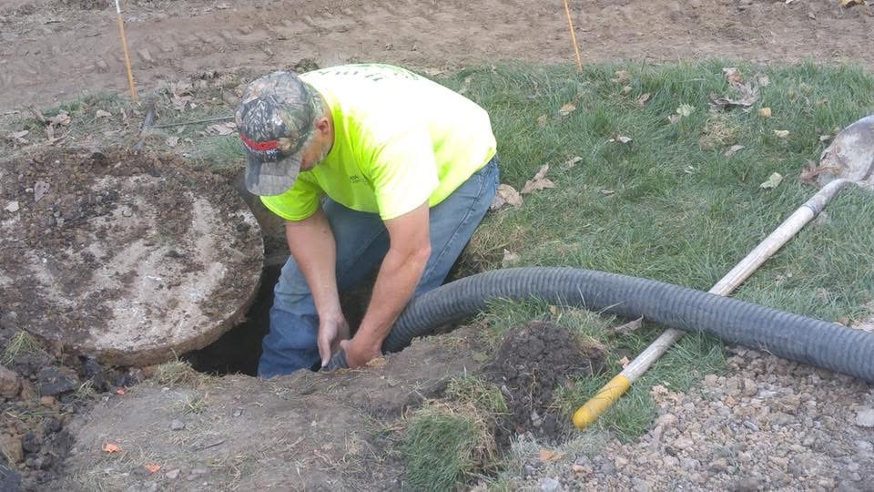 Jeff working on a septic tank opening